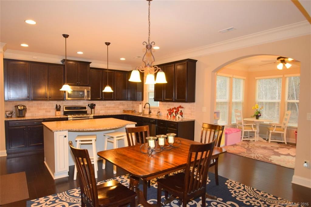3034 Fallondale Road Waxhaw, NC 28173 - Photo 8 of 22 a kitchen with a table chairs sink and cabinets