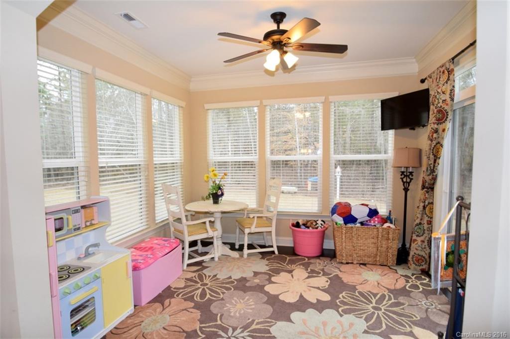3034 Fallondale Road Waxhaw, NC 28173 - Photo 9 of 22 a living room with furniture a flat screen tv and a floor to ceiling window