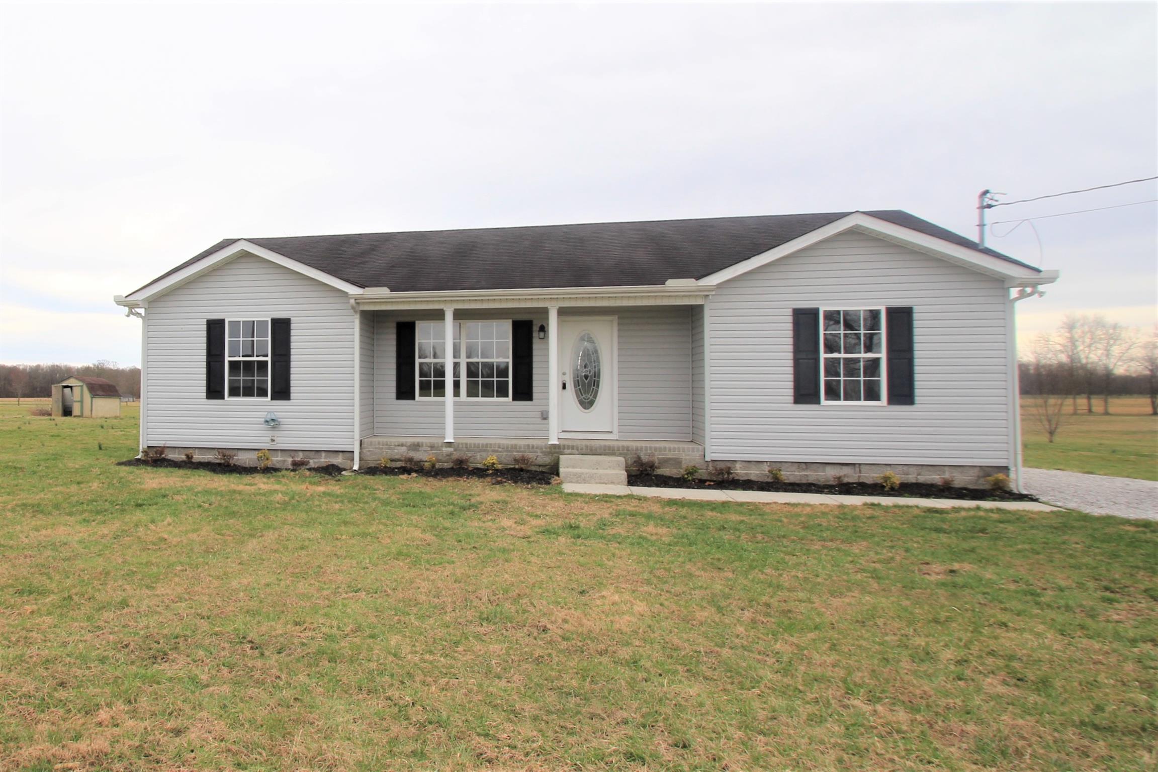 131 Spry Road Morrison, TN 37357 - Photo 1 of 11 a house that has a big yard with wooden fence