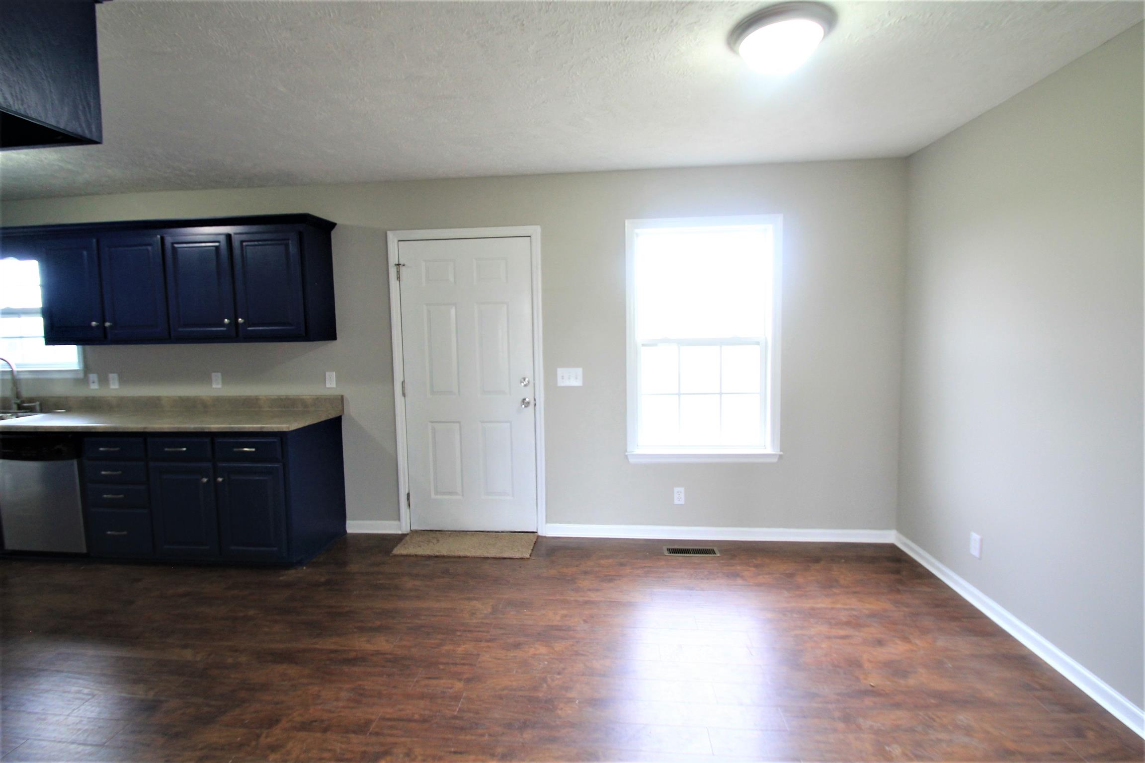 131 Spry Road Morrison, TN 37357 - Photo 6 of 11 an empty room with wooden floor and window