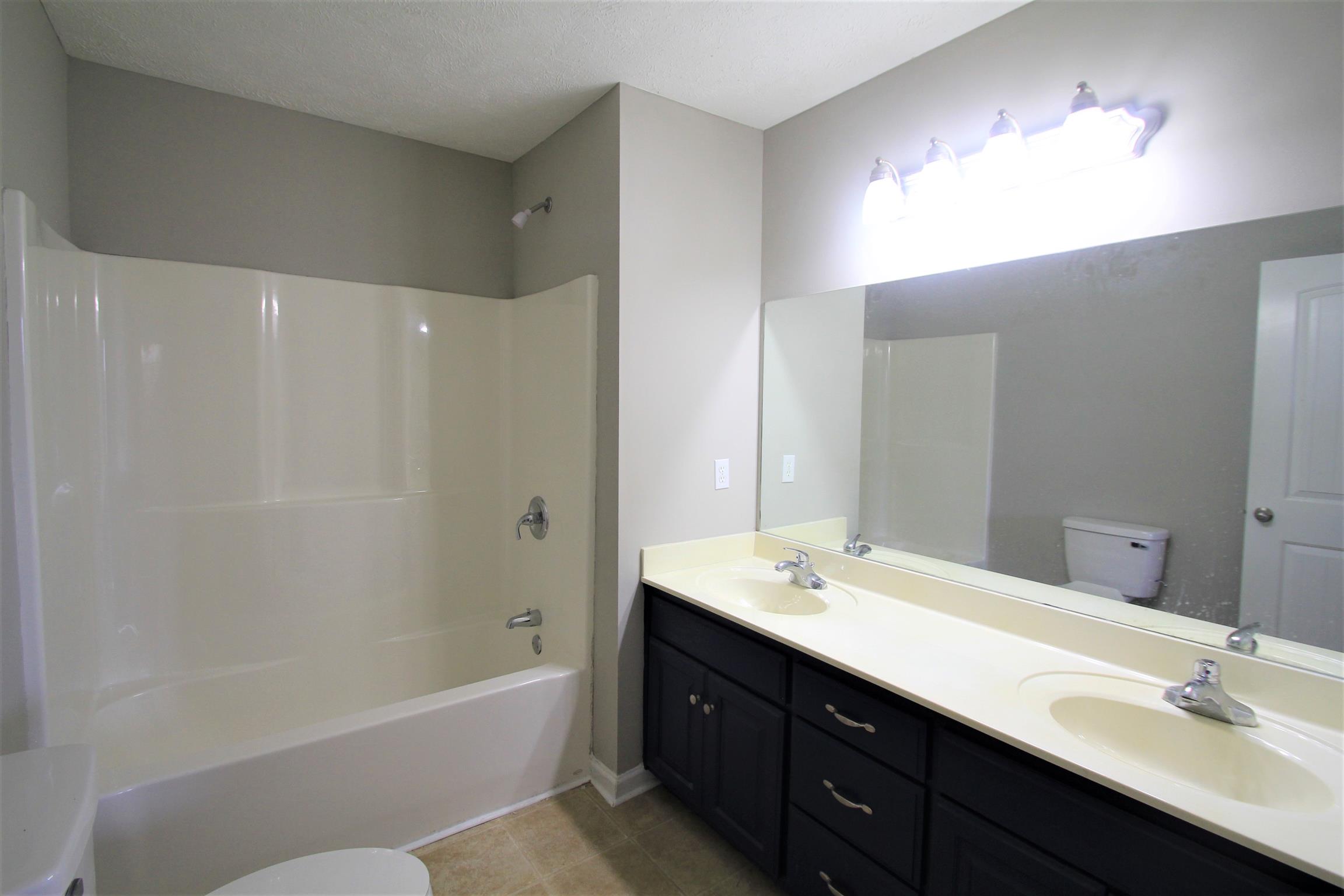 131 Spry Road Morrison, TN 37357 - Photo 8 of 11 a bathroom with a tub sink double vanity and a mirror