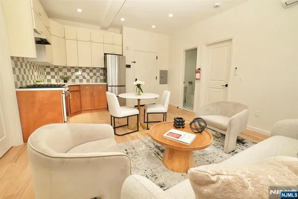 a living room with furniture and a chandelier