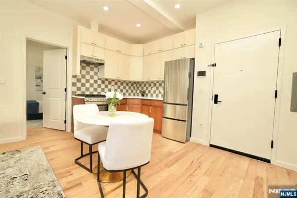 a kitchen with stainless steel appliances granite countertop a refrigerator and a stove top oven