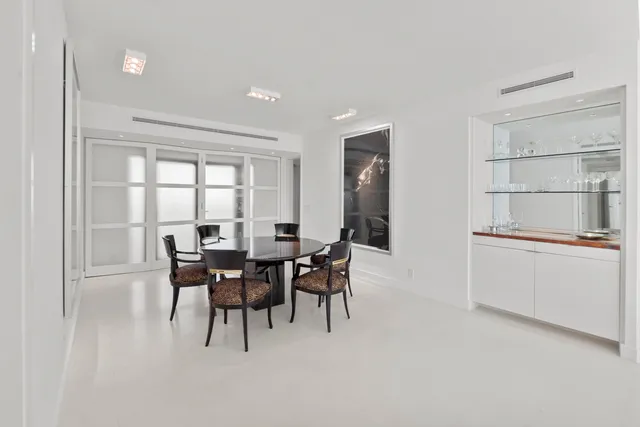 a view of a kitchen with fridge and wooden floor