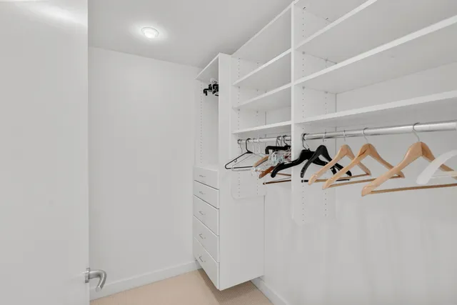 an aerial view of residential houses with outdoor space and lakeside