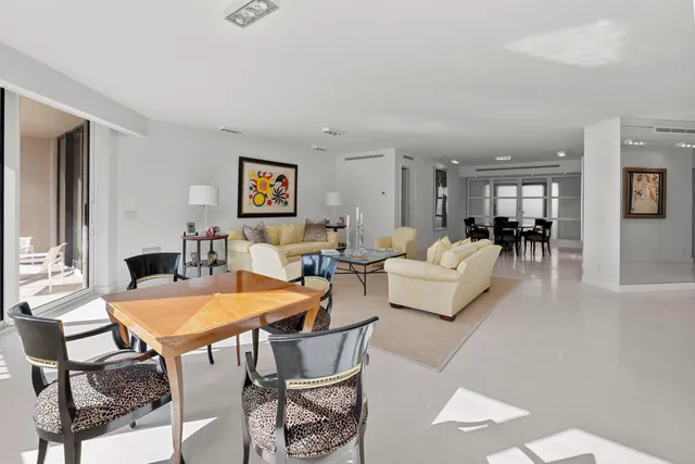 a bedroom with a bed couch and a large window