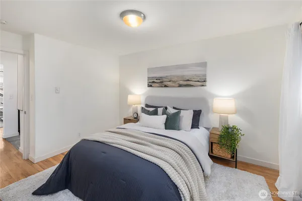 a bedroom with a bed and a potted plant