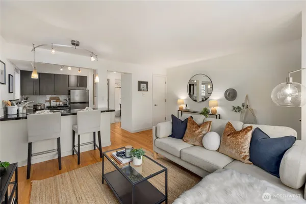 a living room with furniture and wooden floor