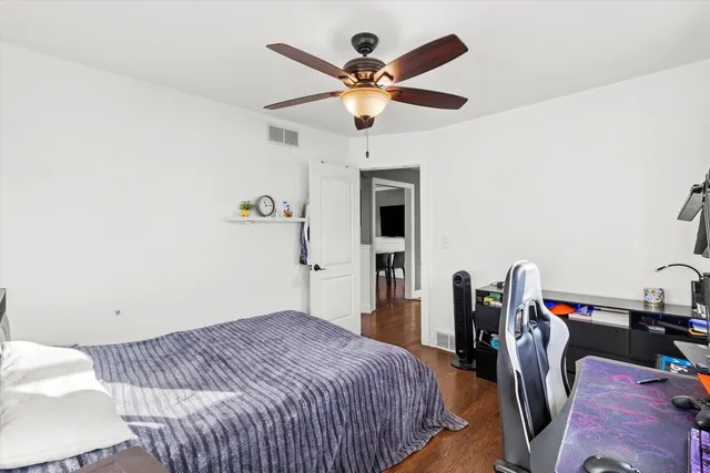 a bedroom with a bed and ceiling fan