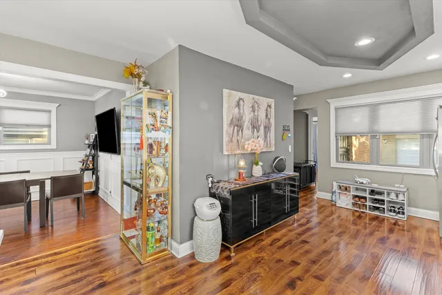 a living room with furniture a flat screen tv and wooden floor