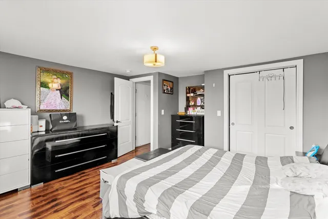 a bedroom with a bed and a television