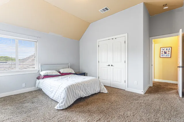 a bedroom with a bed and a window