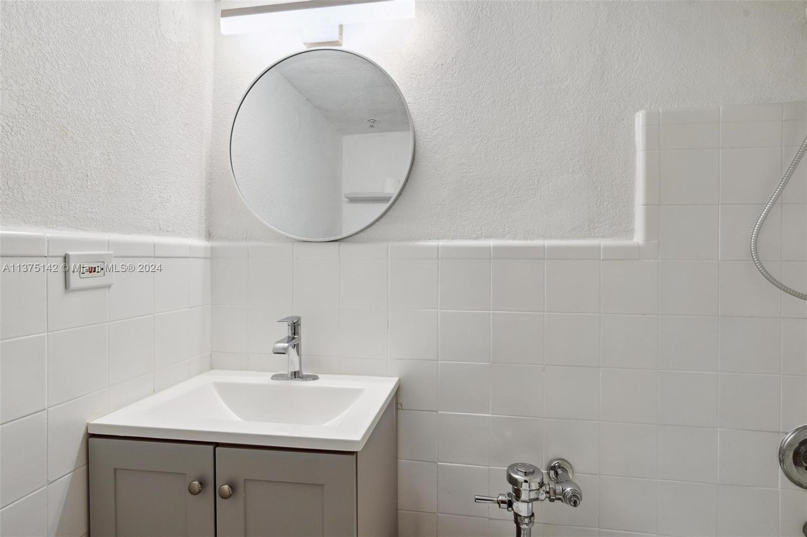 1500 Bay Road, Unit 1556S Miami Beach, FL 33139 - Photo 13 of 13 a bathroom with a sink and a mirror
