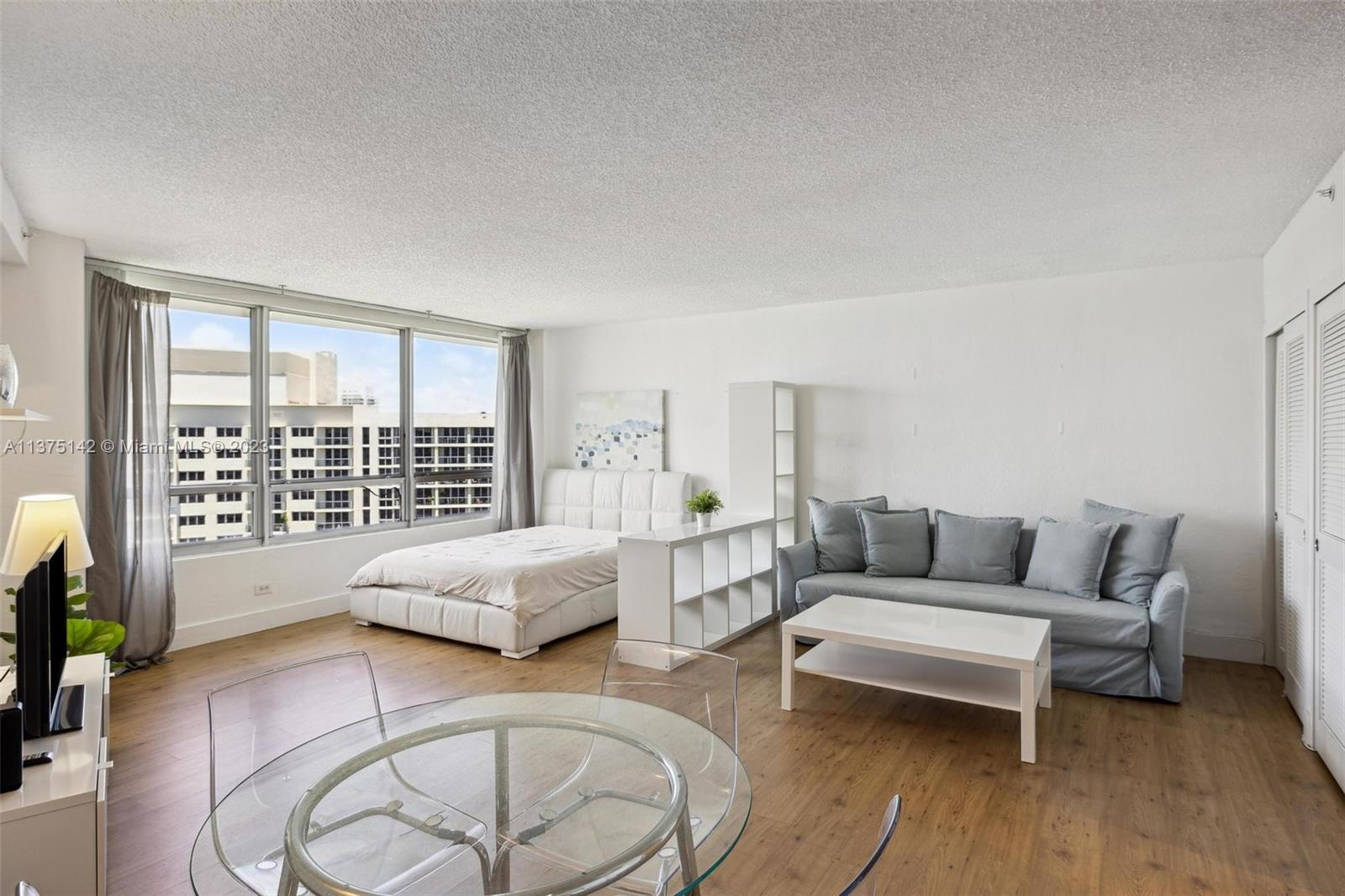1500 Bay Road, Unit 1556S Miami Beach, FL 33139 - Photo 6 of 13 a living room with furniture and a large window