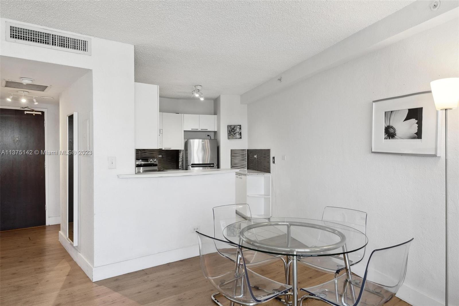 1500 Bay Road, Unit 1556S Miami Beach, FL 33139 - Photo 7 of 13 a kitchen with stainless steel appliances a refrigerator and a stove top oven