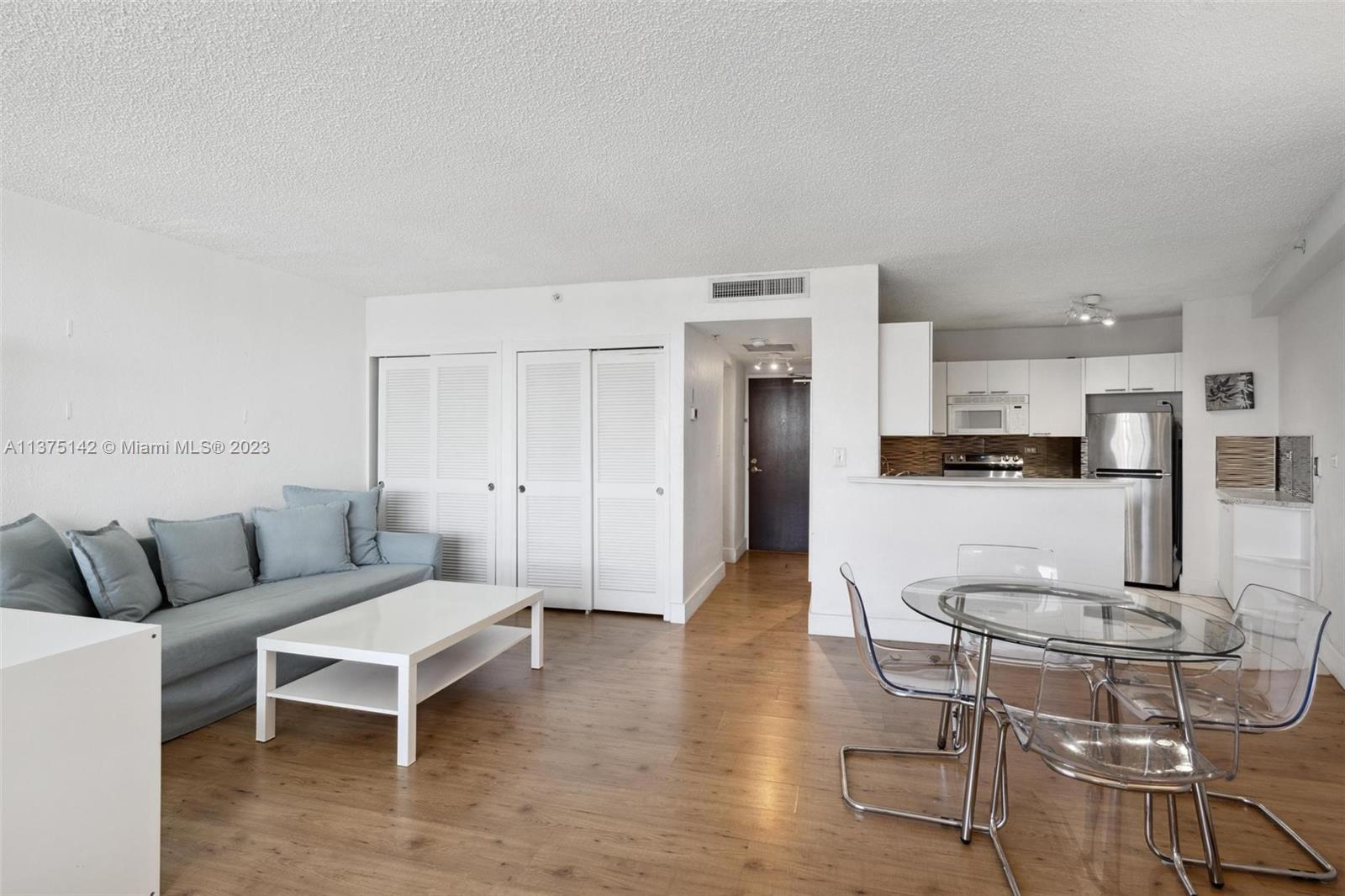 1500 Bay Road, Unit 1556S Miami Beach, FL 33139 - Photo 8 of 13 a living room with furniture and kitchen view