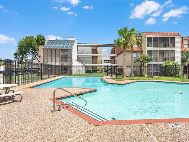 a kitchen with granite countertop a sink and cabinets