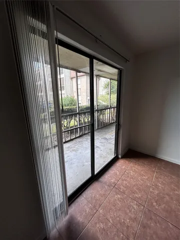 a view of an empty room with a kitchen
