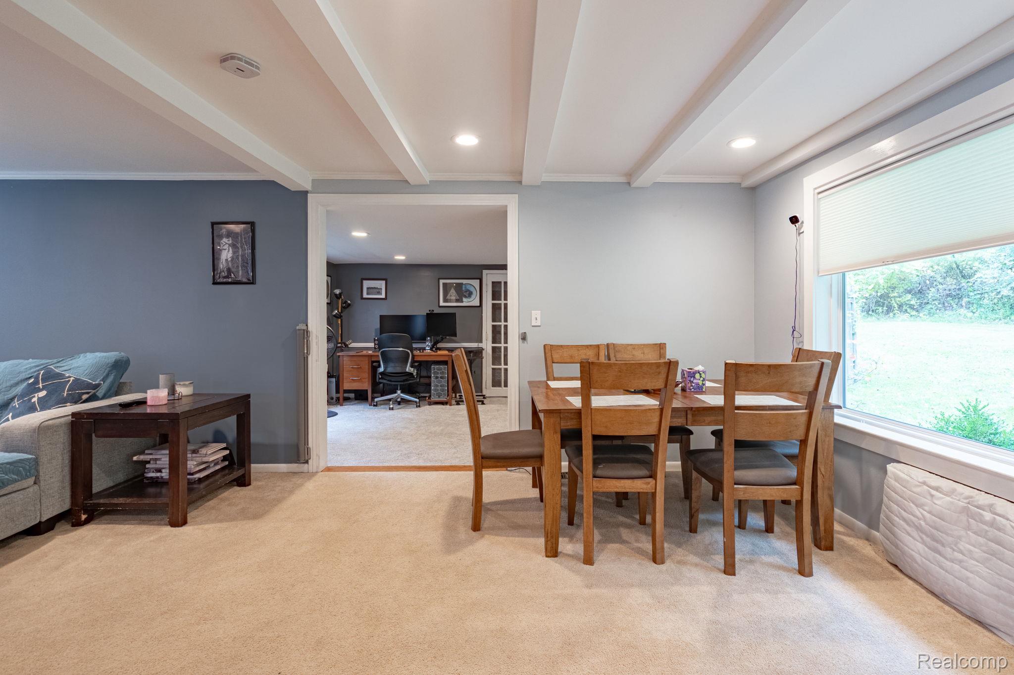 1775 Porter Road White Lake, MI 48383 - Photo 25 of 33 Recessed lighting, exposed ceiling beams, and a large window with privacy blinds