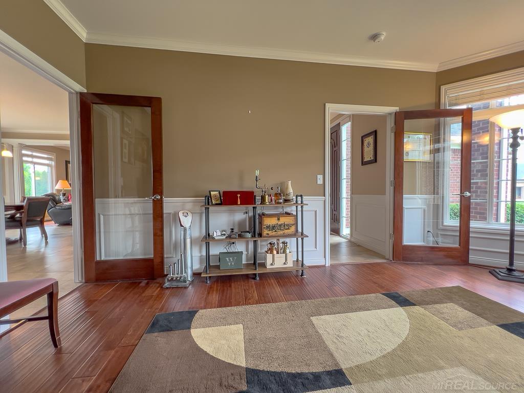 16070 Moore Park Road Macomb, MI 48044 - Photo 21 of 76 Enjoy the 2 decorative glass doors that lead to to the foyer and the kitchen/dining.