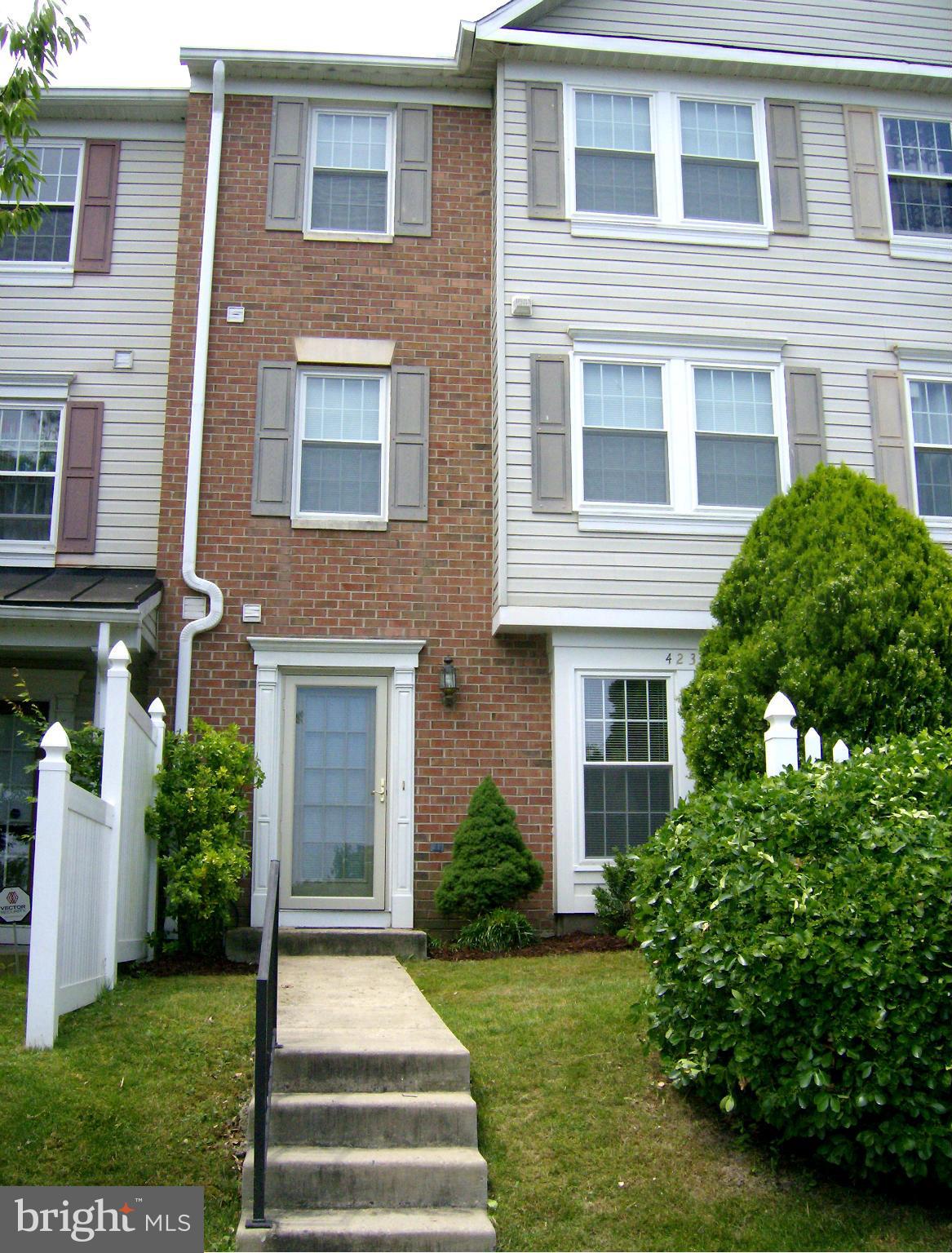 4230 Maple Path Circle, Unit 19 Nottingham, MD 21236 - Photo 1 of 19 a front view of a house with garden and trees