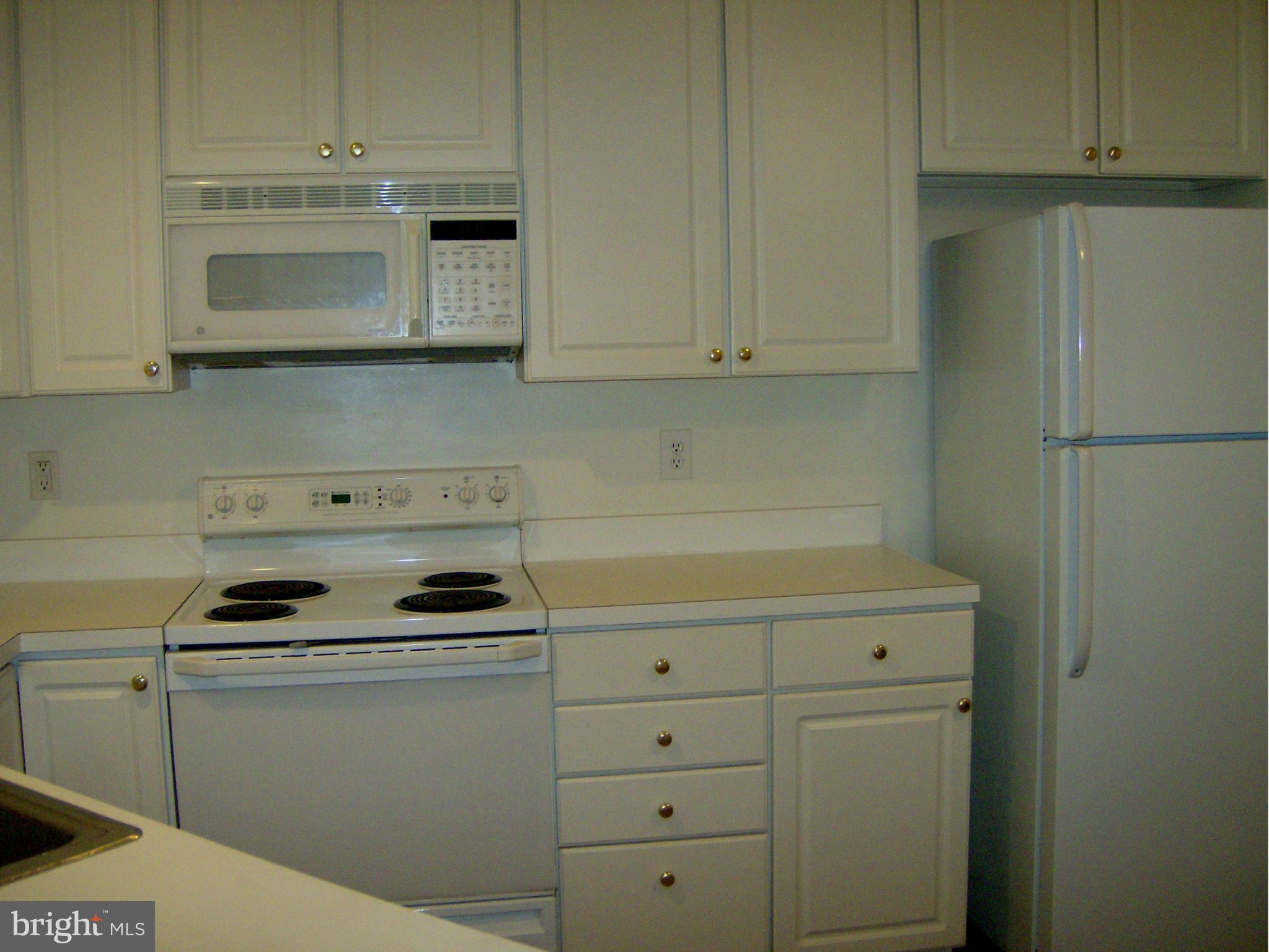 4230 Maple Path Circle, Unit 19 Nottingham, MD 21236 - Photo 12 of 19 a kitchen with stainless steel appliances white cabinets and stove top oven