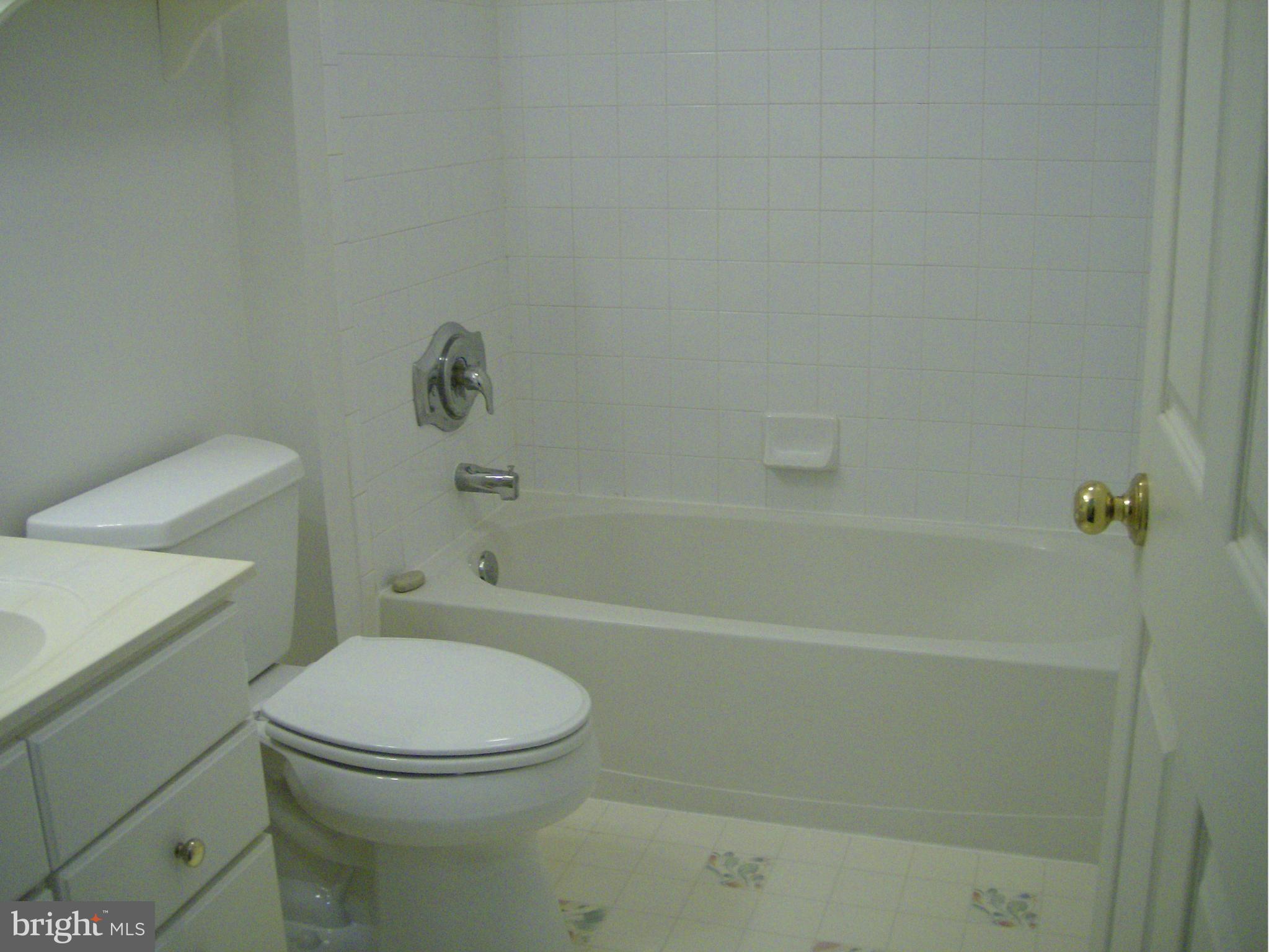 4230 Maple Path Circle, Unit 19 Nottingham, MD 21236 - Photo 16 of 19 a white toilet and tub sitting next to a bathroom sink