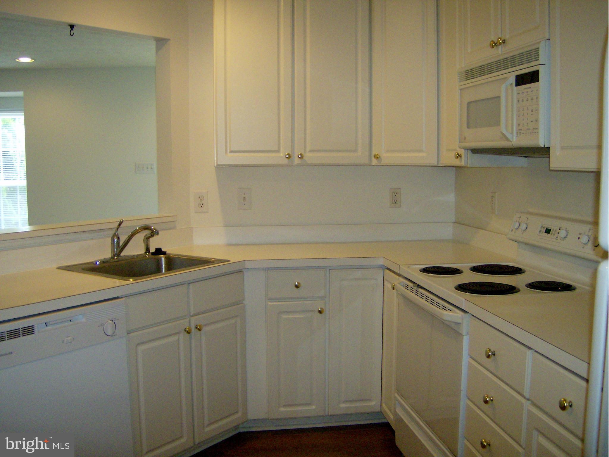 4230 Maple Path Circle, Unit 19 Nottingham, MD 21236 - Photo 3 of 19 a kitchen with white cabinets and sink