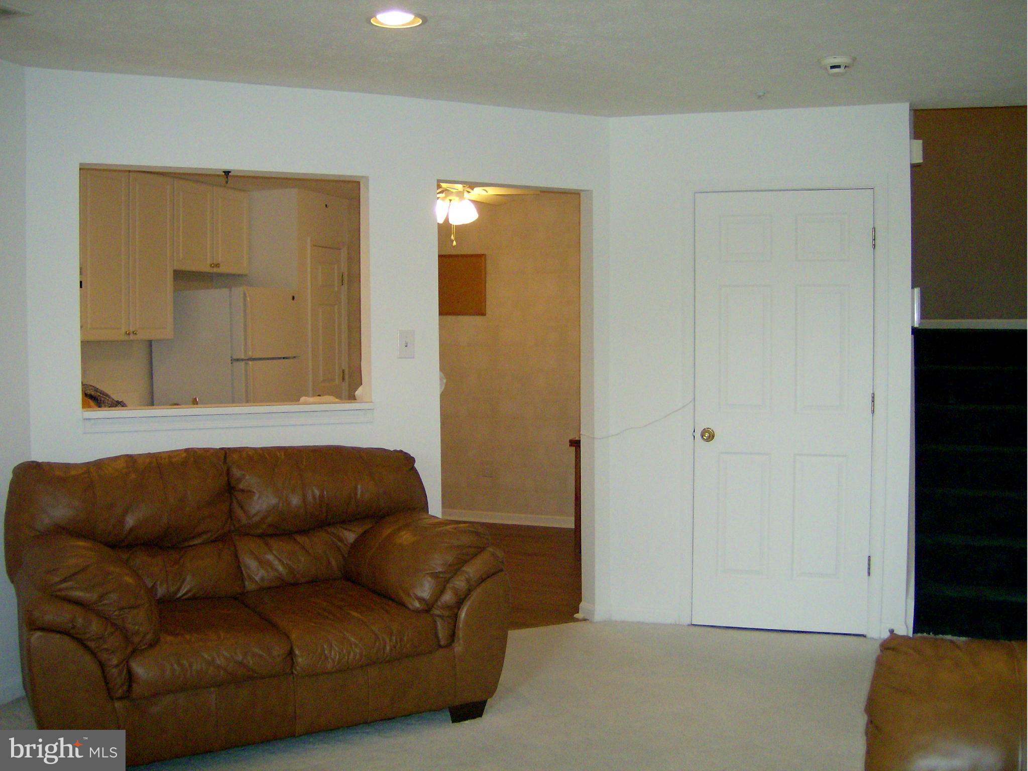 4230 Maple Path Circle, Unit 19 Nottingham, MD 21236 - Photo 9 of 19 a living room with a couch and a dresser