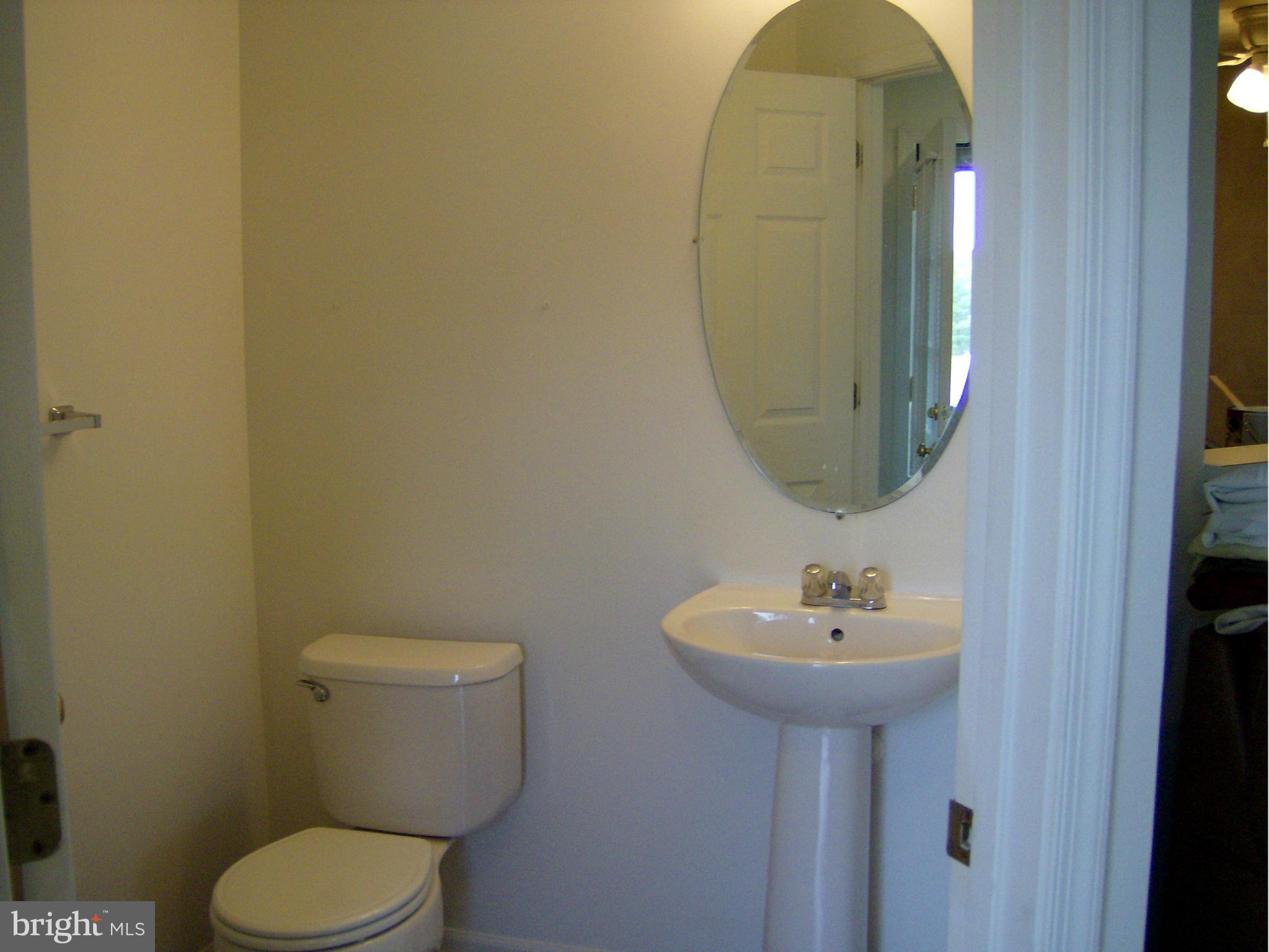 4230 Maple Path Circle, Unit 19 Nottingham, MD 21236 - Photo 10 of 19 a bathroom with a toilet sink and mirror