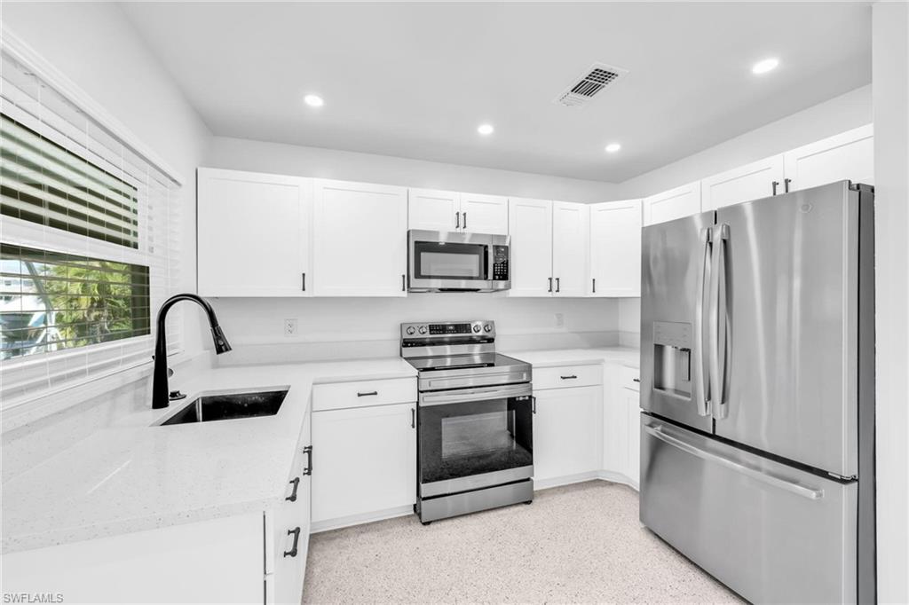 2822 Bruce Street Matlacha, FL 33993 - Photo 15 of 26 a kitchen with a refrigerator sink and stove