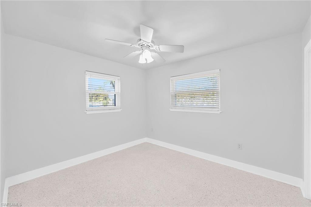 2822 Bruce Street Matlacha, FL 33993 - Photo 21 of 26 an empty room with a window and ceiling fan