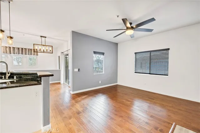a view of a kitchen with a sink dishwasher a refrigerator with wooden floor