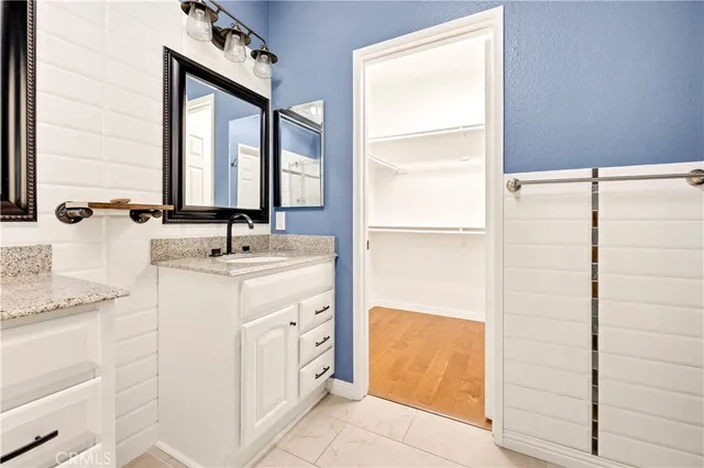 a bathroom with a double vanity sink a mirror and a shower