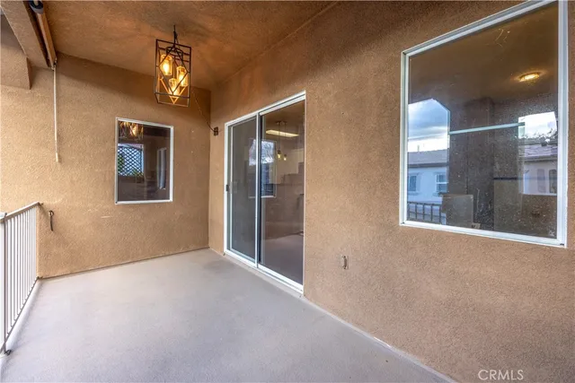 en empty room with windows and chandelier