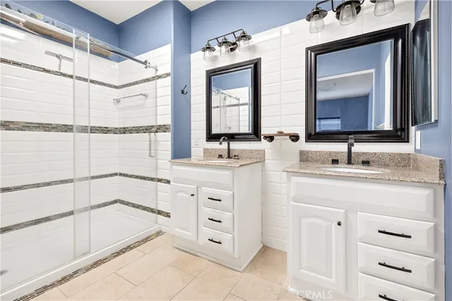 a bathroom with a double vanity sink mirror and
