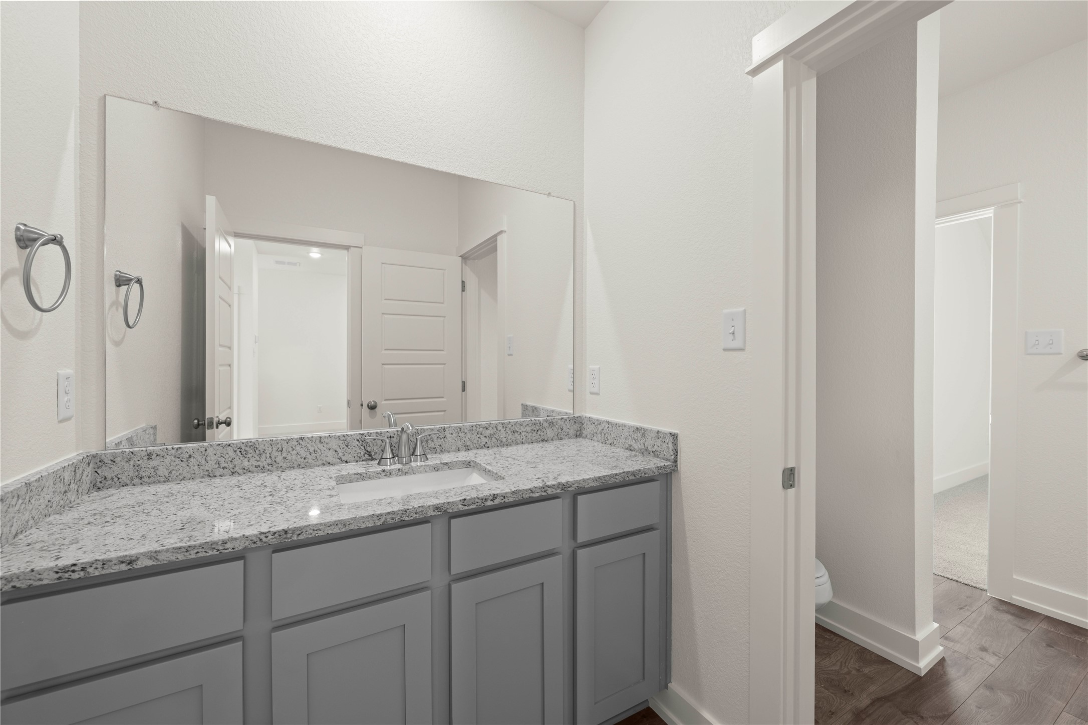 564 Gus Loop Georgetown, TX 78626 - Photo 27 of 32 a bathroom with a granite countertop sink and a mirror