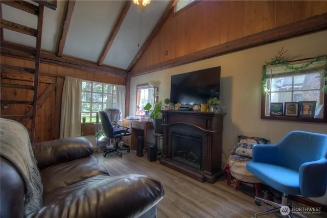 a living room with furniture a flat screen tv and a fireplace