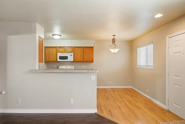 a view of a kitchen with wooden floor and a sink