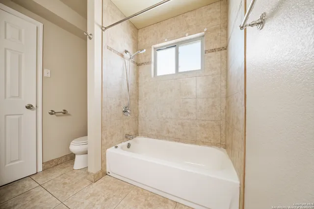 a bathroom with a bathtub and a toilet