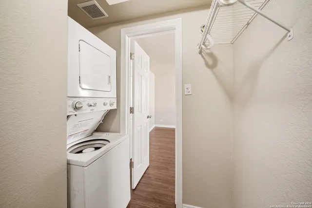 a view of a hallway with washer and dryer