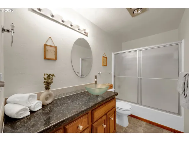 a bedroom with a bed a chandelier and a window