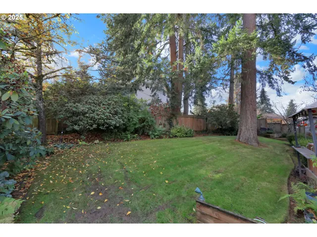 an outdoor sitting area with wooden fence