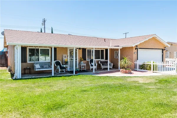 a house view with swimming pool and porch