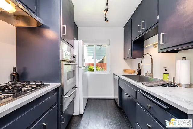 a kitchen with a sink stove and refrigerator