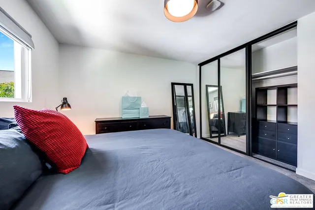 a bedroom with furniture and window