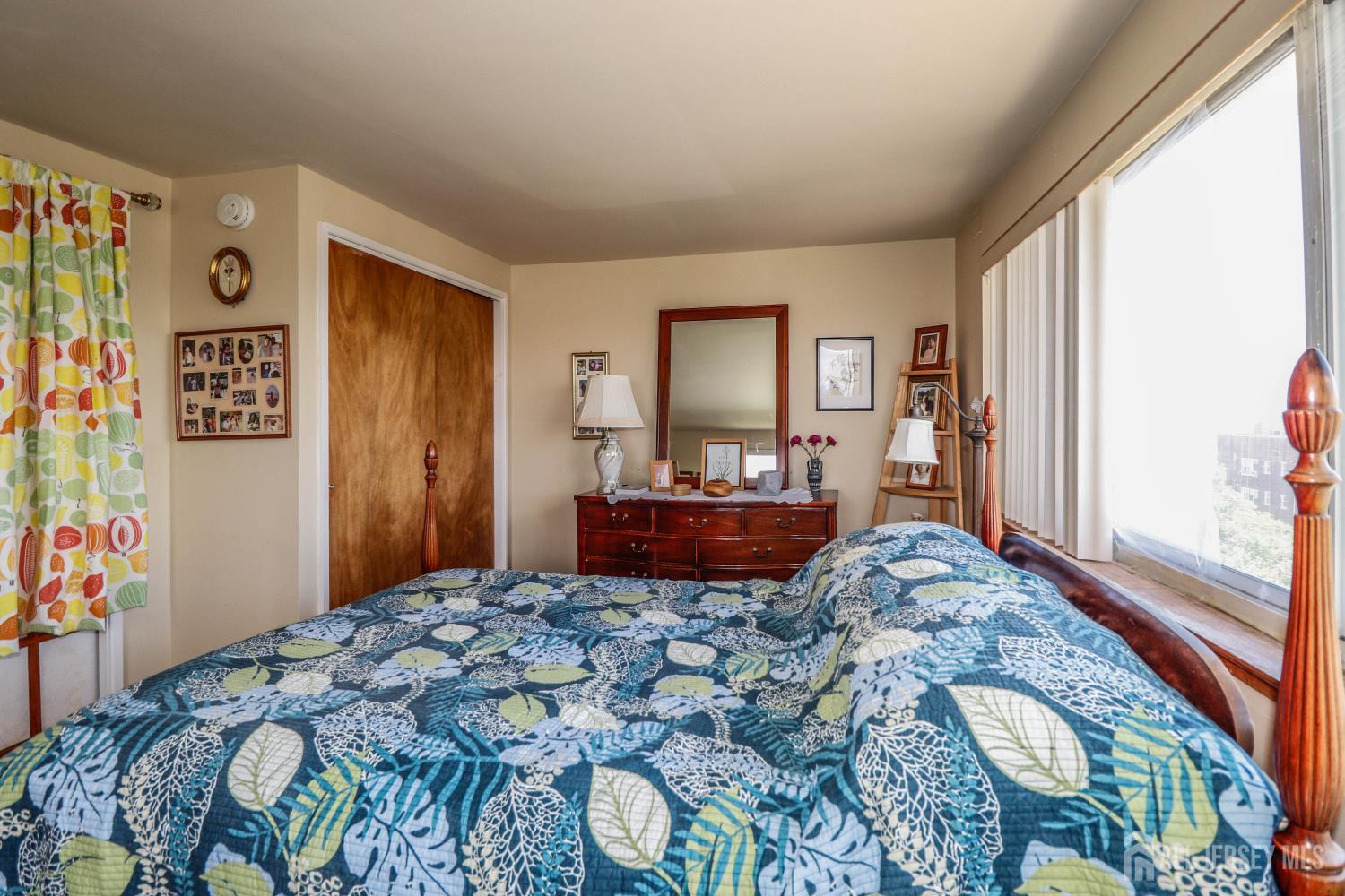 40 Fayette Street, Unit 57 Perth Amboy, NJ 08861 - Photo 21 of 33 a bed sitting in a bedroom next to a window