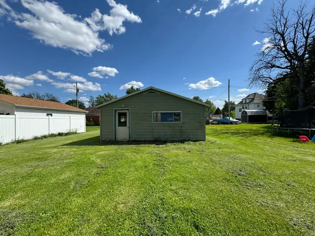 a yellow house with garden in front of it