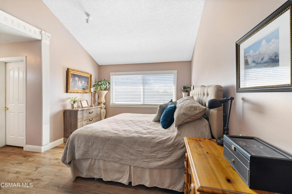 5914 Cochran Street Simi Valley, CA 93063 - Photo 11 of 23 a bedroom with a bed and wooden floor