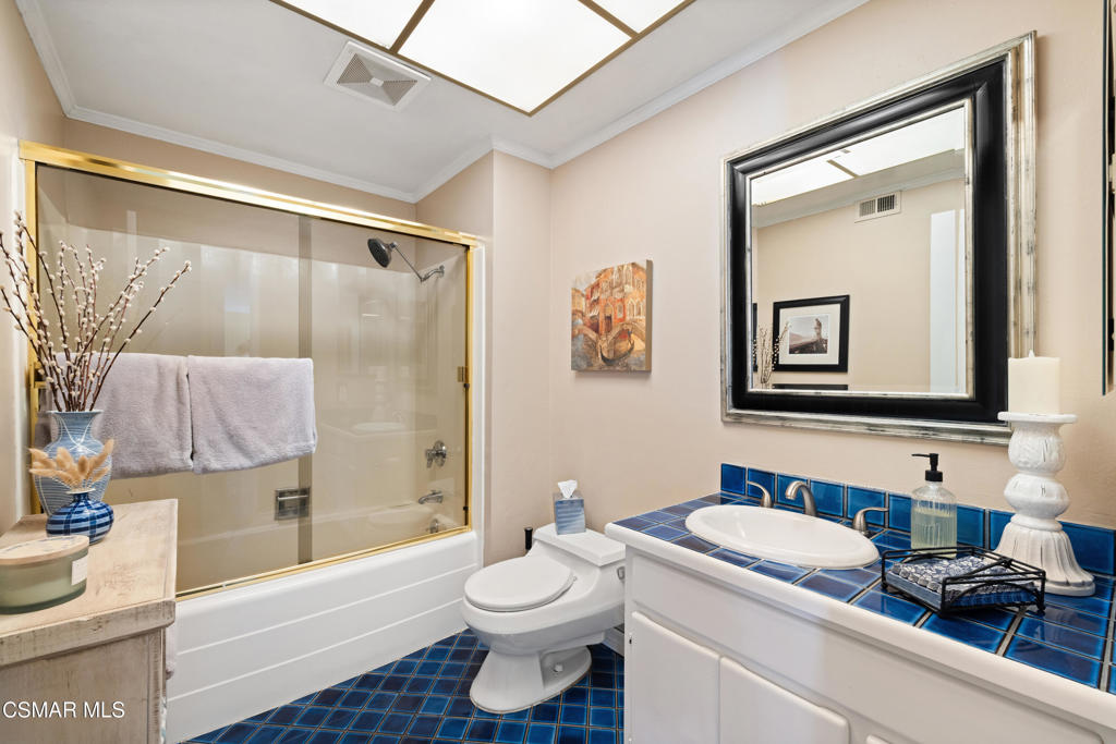 5914 Cochran Street Simi Valley, CA 93063 - Photo 17 of 23 a bathroom with a granite countertop toilet sink and mirror